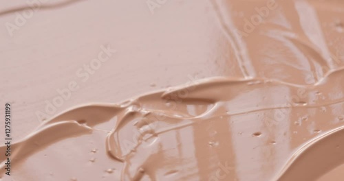 Liquid make up foundation or concealer cosmetic texture close up. Beauty abstract
