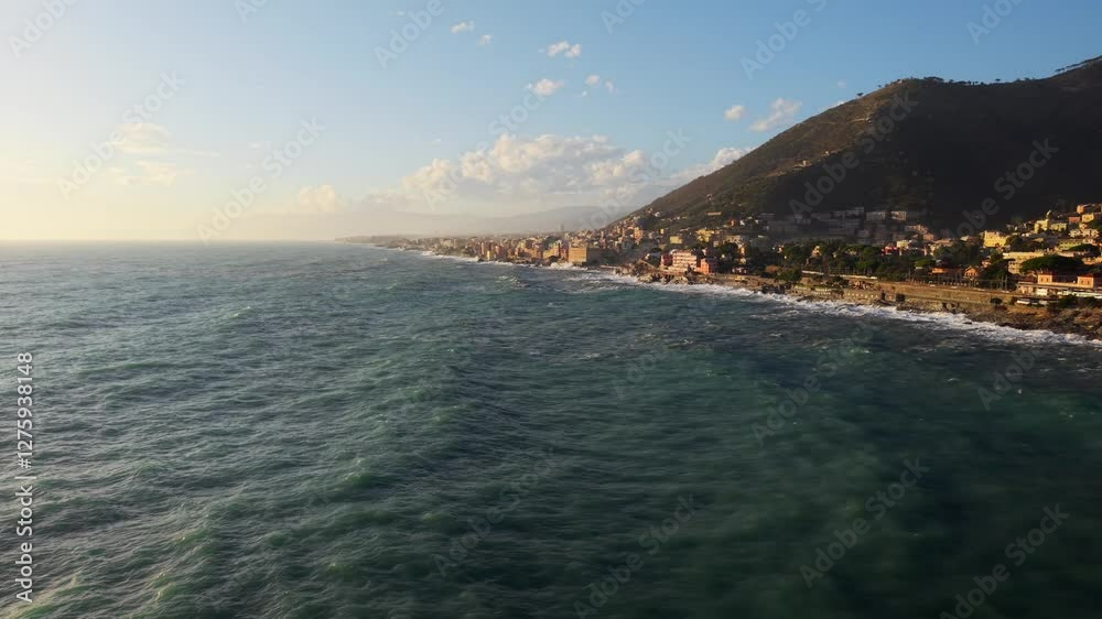 Big waves crashing along the coastal city of Liguria, Italy, at sunset Big waves crashing along the coastal city of Liguria, Italy, at sunset