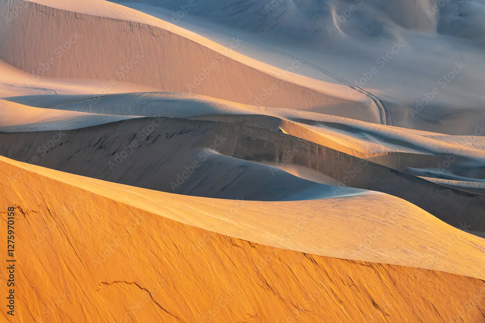 Sand dunes curves, abstract landscape at sunset in Sandwich Harbour, Namib Naukluft Natural Park in Namibia, Africa