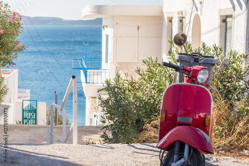 Red Motorbike Overlooking Sea in Adamas, Milos Island, Greece photo