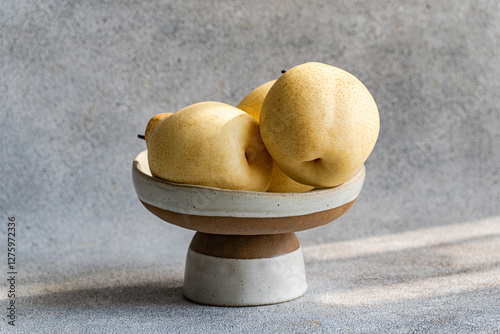 Elegant display of Chinese white pears in ceramic bowl