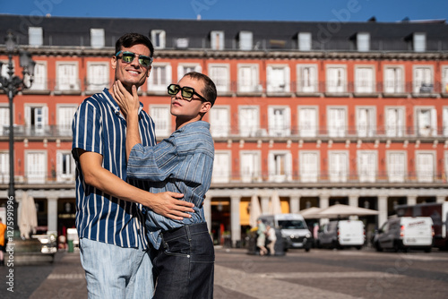 Gay couple embracing in vibrant Madrid streets imagery photo