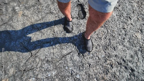 Tourist enjoying a walk on the therapeutic mud of the pink salty sasyk sivash lake in crimea photo