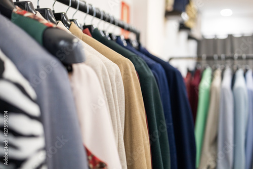 Close up of colorful clothes on hangers in a suit store photo