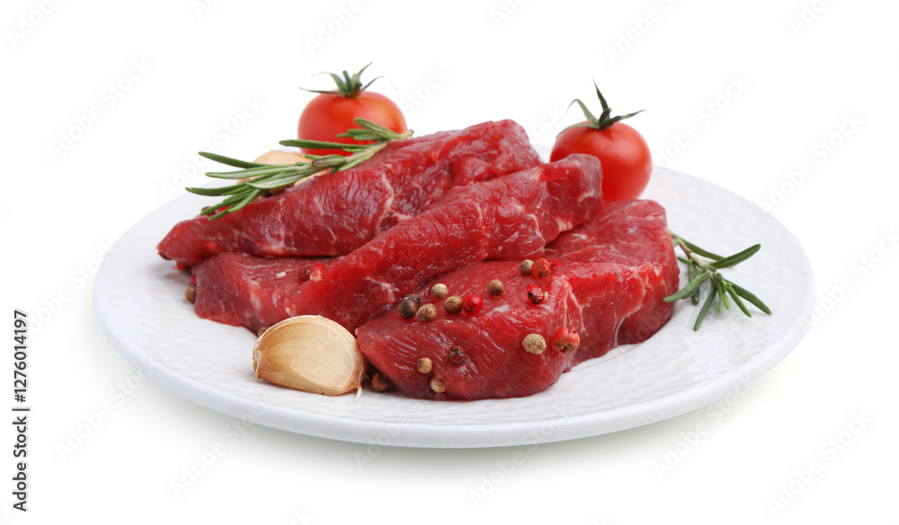 Pieces of raw beef meat, spices and tomatoes isolated on white Pieces of raw beef meat, spices and tomatoes isolated on white