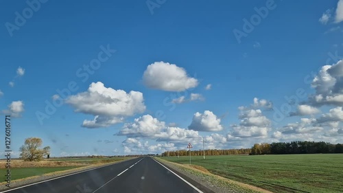 The car is walking along a scenic road. Dense forest near the highway.