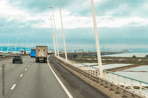 Traffic on the Vasco da Gama Bridge (Portuguese: Ponte Vasco da Gama) is a cable-stayed bridge in a rainy day. Lisbon, Portugal.