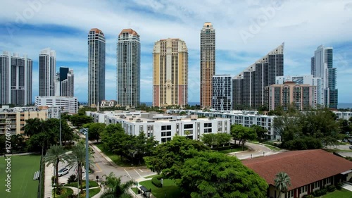 Sunny Isles Beach, Florida - July 13, 2024: Aerial of midrise condos and tall beachfront residential skyscrapers.