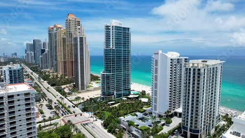 Sunny Isles Beach, Florida - Aerial of premium residential condos lining the beach.