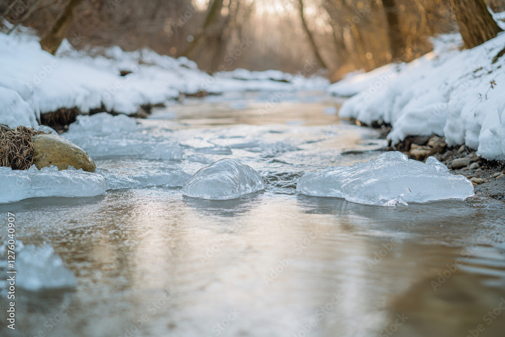 Melting ice floating in creek, with clear water and soft light Melting ice floating in creek, with clear water and soft light