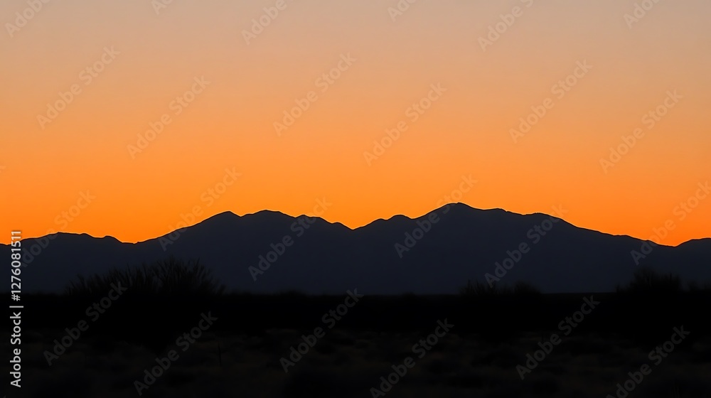 Silhouetted Mountains at Sunset Vibrant Orange Sky