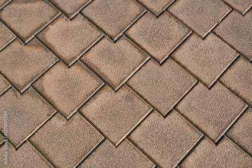 Brown terra cotta floor tiles. Anti-slip brown stone tiles for outdoor flooring. Selective focus