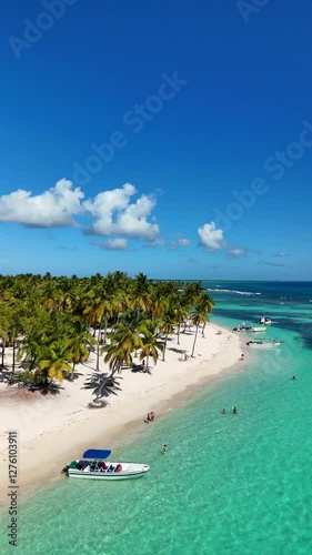 Drone view of Saona Island, turquoise waters, white sand, boats and a pure tropical paradise in the Dominican Republic.