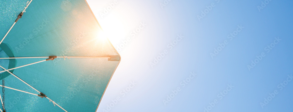 beach sun umbrella on blue summer sky