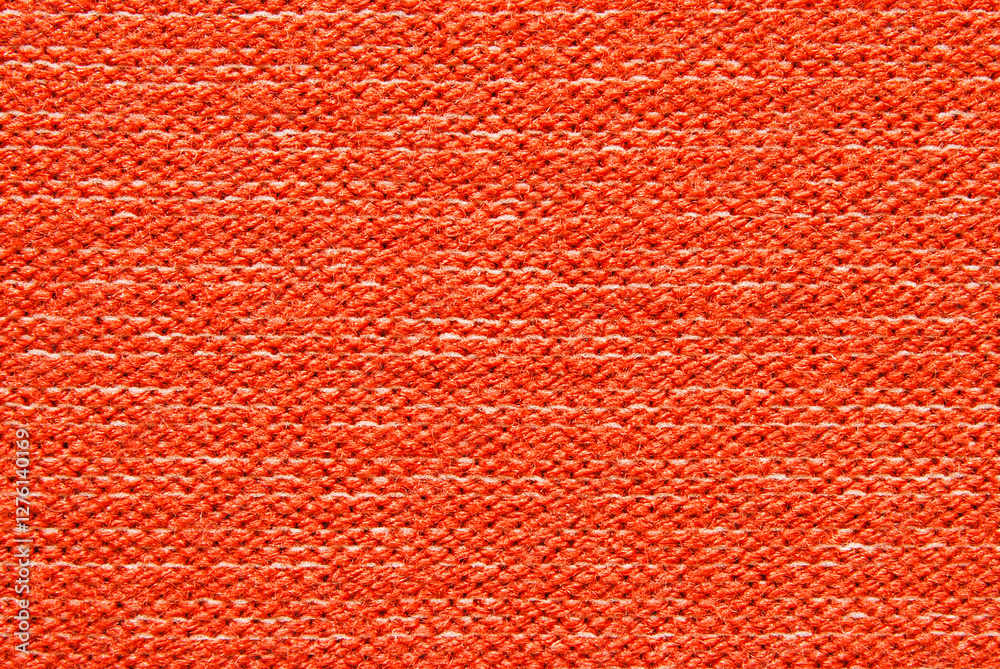 Red purl wool jersey fabric texture as background Red purl wool jersey fabric texture as background