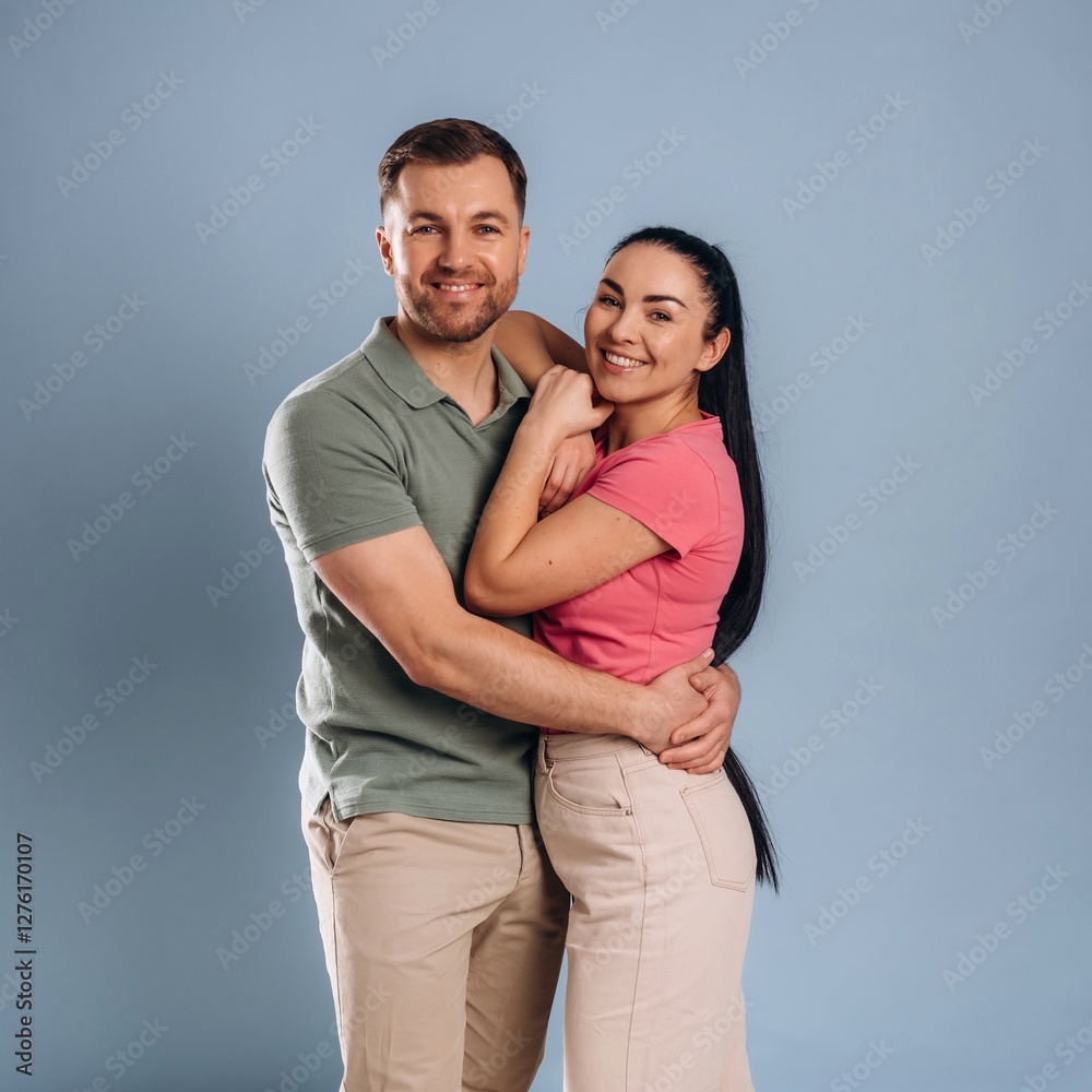 Embracing, standing and posing. Man and woman are in the studio Embracing, standing and posing. Man and woman are in the studio