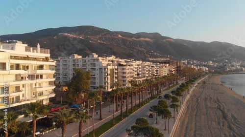 Vlora, albania at sunset with urban landscape and surrounding hills in the distance, aerial view