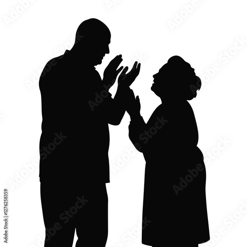 Elderly Hispanic couple applauding together in silhouette, human emotions