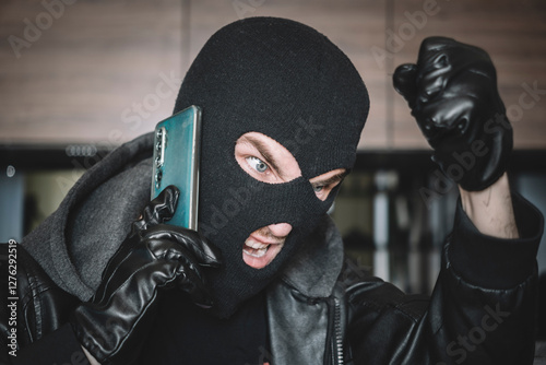 Obraz na plátne thief is talking on phone in black mask