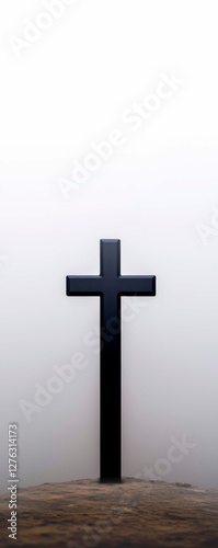 Solitary Black Cross on Hilltop in Overcast Setting Religious Symbol of Faith and Reflection photo