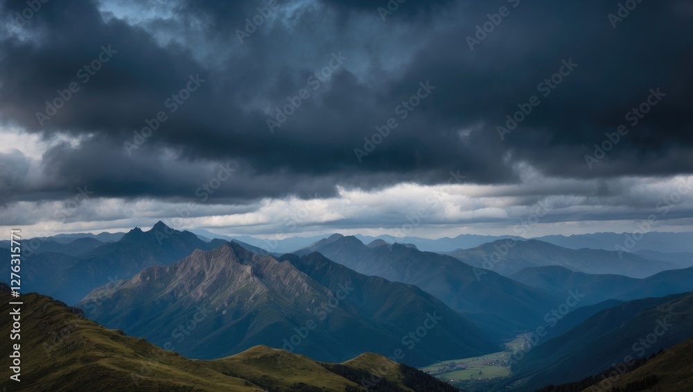 Mountain landscape under dramatic cloudy sky with multiple mountain ranges and lush green valleys in foreground. Mountain landscape under dramatic cloudy sky with multiple mountain ranges and lush green valleys in foreground.