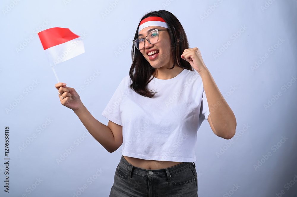 Asian woman with glasses, wearing a white crop top and a red-and-white headband, holding an Indonesian flag while cheering. She looks excited and patriotic. White background. Asian woman with glasses, wearing a white crop top and a red-and-white headband, holding an Indonesian flag while cheering. She looks excited and patriotic. White background.