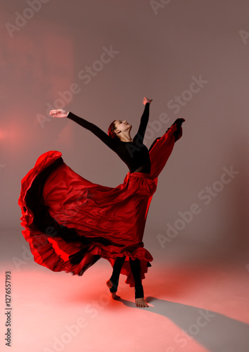Beautiful young woman dancer dancing. dance elements photoshoot. Dancer in long skirt spanish dance