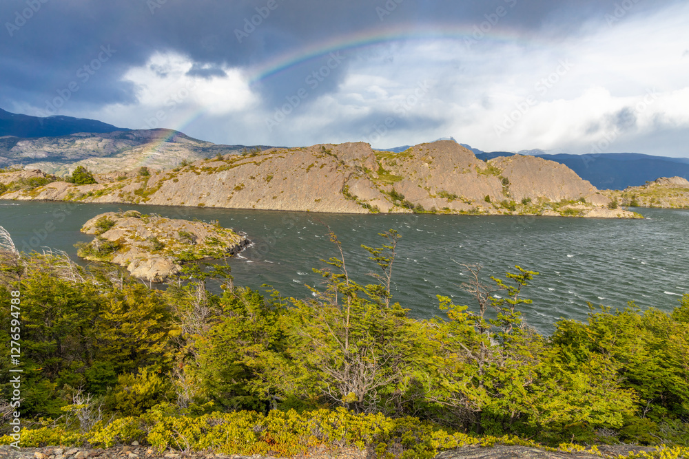 Fototapeta premium Torres del Paine national park mountain landscape in Patagonia, Chile. Los Cuernos and Torres del Paine peak granite towering summits on a nasty and sunny day above the blue water lake in the Andes