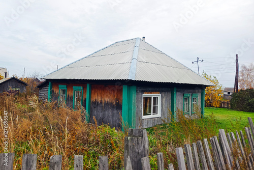 one-story old dilapidated house in a Russian village. Cheap suburban housing for the poor.