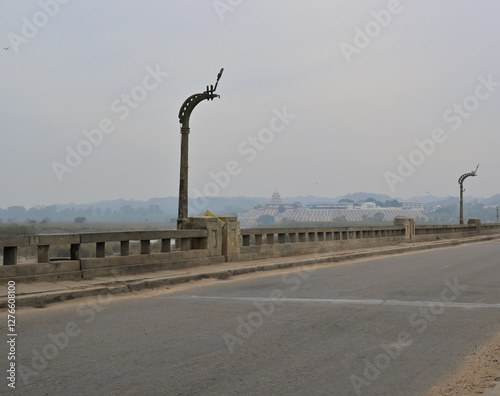 Concrete bridge with distinctively shaped light poles and open balustrades.