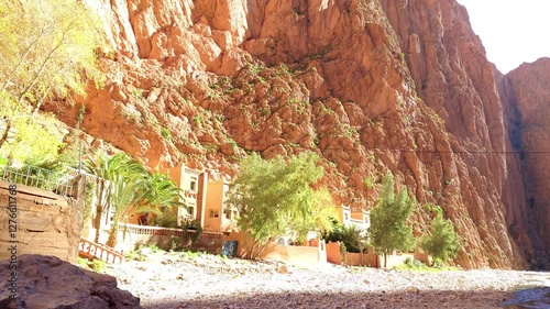 Scenic mountain gorge with steep rocky cliffs under a clear blue sky in Todra Gorge, Morocco