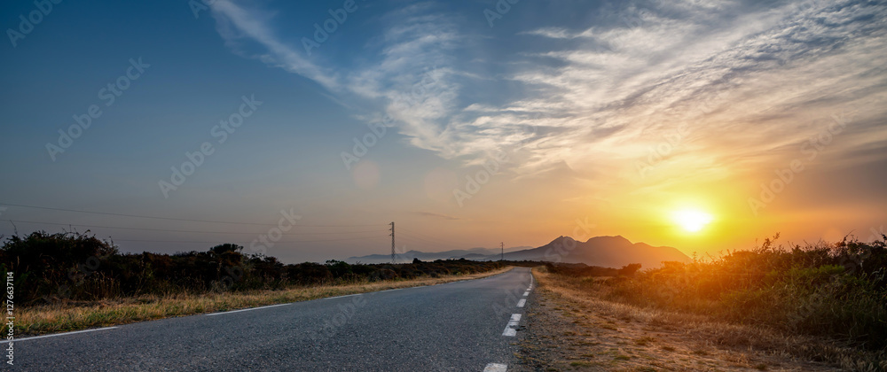 Mediterranean sea coast road into mountains horizon in summer with beautiful bright sun rays
