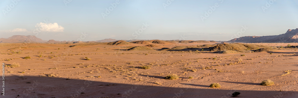 long shadows on sandy desert and little hills from above, near Twyfelfontein, Namibia