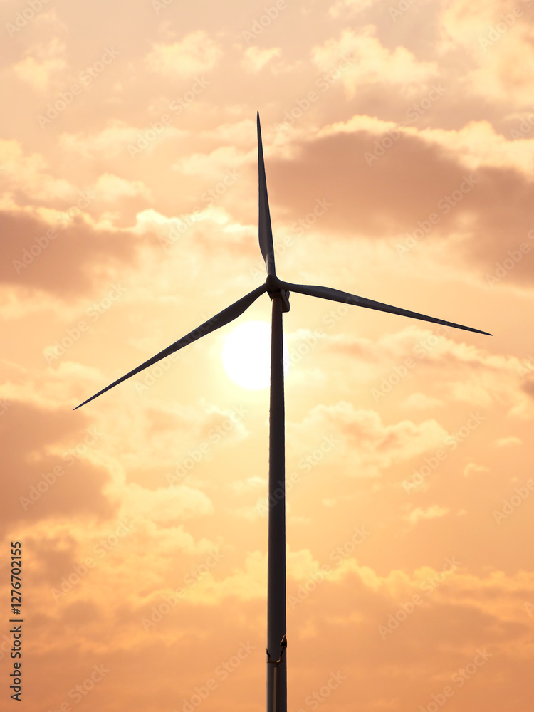 Renewable Energy Silhouette: A single wind turbine stands tall against a vibrant, cloudy sky, symbolizing sustainable energy and environmental consciousness. Renewable Energy Silhouette: A single wind turbine stands tall against a vibrant, cloudy sky, symbolizing sustainable energy and environmental consciousness.