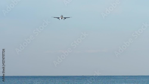 Wallpaper Mural Passenger aircraft with unrecognizable livery flying over blue sea. Airplane descending landing, long shot Torontodigital.ca