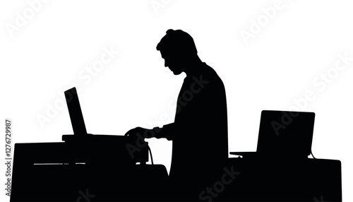 Silhouette of a DJ mixing music at a computer