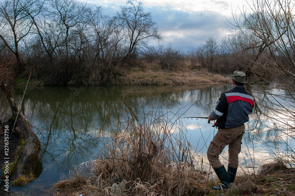 a fisherman throws a fishing rod into a large lake a fisherman throws a fishing rod into a large lake