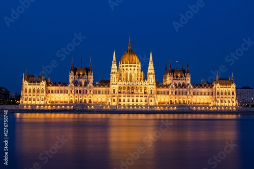 Hungarian Parliament at night with river reflection. photo