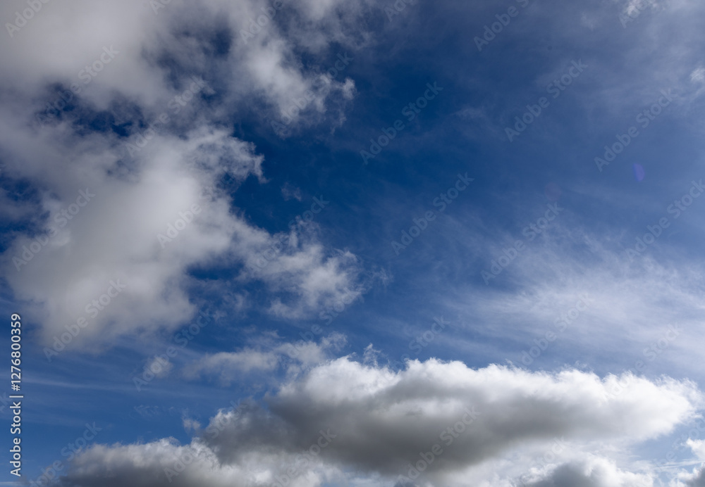 The sky is endless and deep blue, with cotton-like clouds scattered. Some clouds are light and airy, while others are dense, making the scene visually rich. The sky is endless and deep blue, with cotton-like clouds scattered. Some clouds are light and airy, while others are dense, making the scene visually rich.