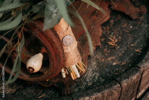 Wedding bouquet handle wrapped in canvas rope against rusty sewing machine. photo