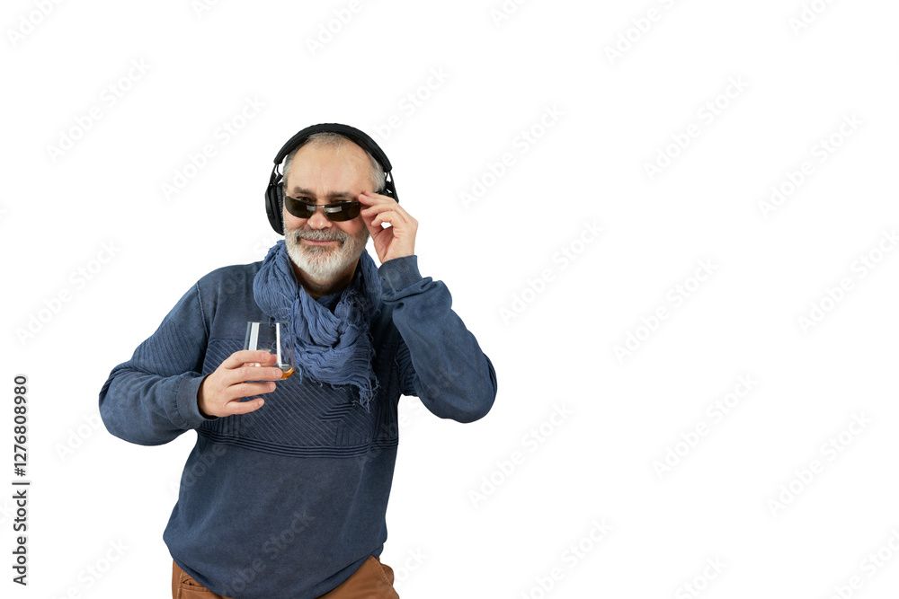 Naklejka premium An adult gray-haired man enjoys listening to music with wireless headphones. He holds a glass with an alcoholic drink in his hand. Png.