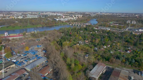 An aerial view of Kraków’s Zabłocie district, showcasing its dynamic transformation along the banks of the Vistula River. Once an industrial area, Zabłocie has evolved into a modern, thriving neighbor