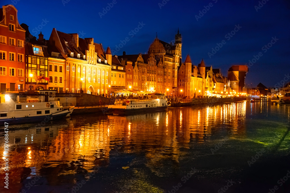 Obraz premium Gdansk old town and famous crane at night. View from Motlawa river. Poland at romantic night. The city also known as Danzig and the city of amber.
