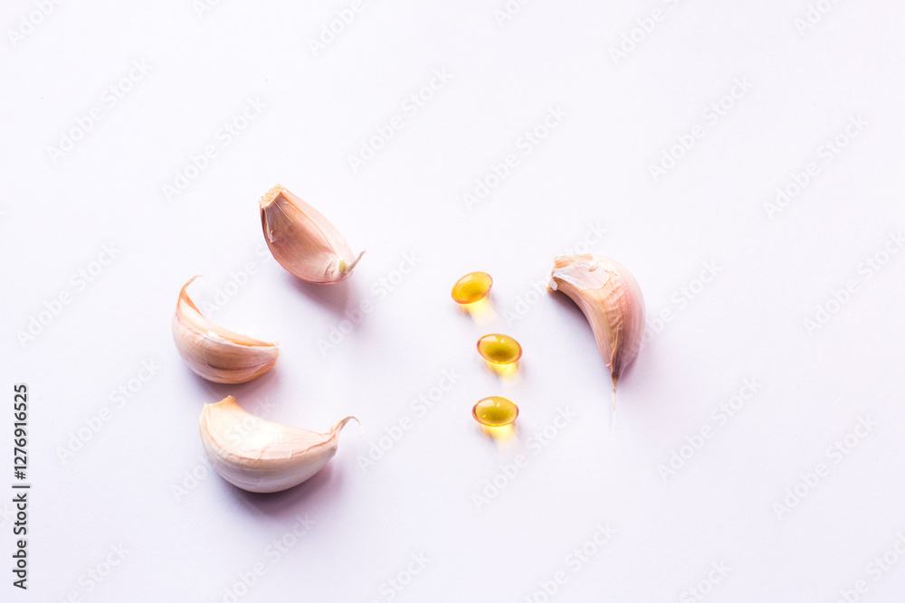 Garlic gel capsules extract on white background Garlic gel capsules extract on white background