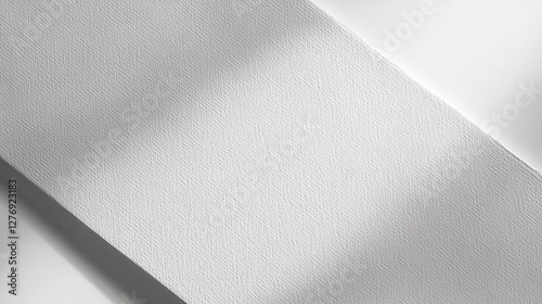 Minimalist textured white surface with light and shadow patterns