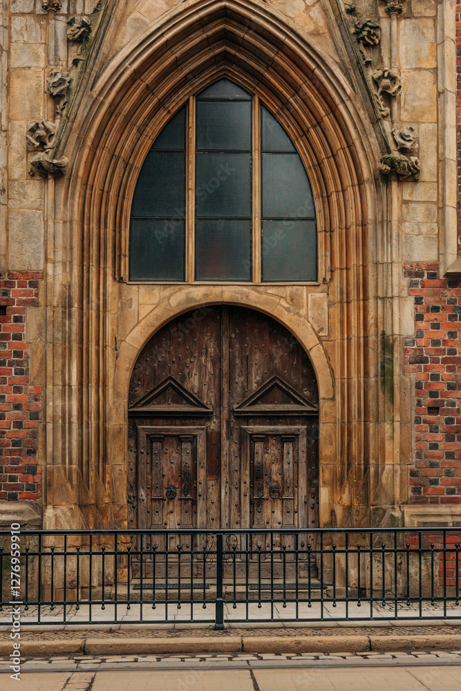 Fototapeta premium The grand church doors of a Gothic-style temple in Wroclaw, Poland
