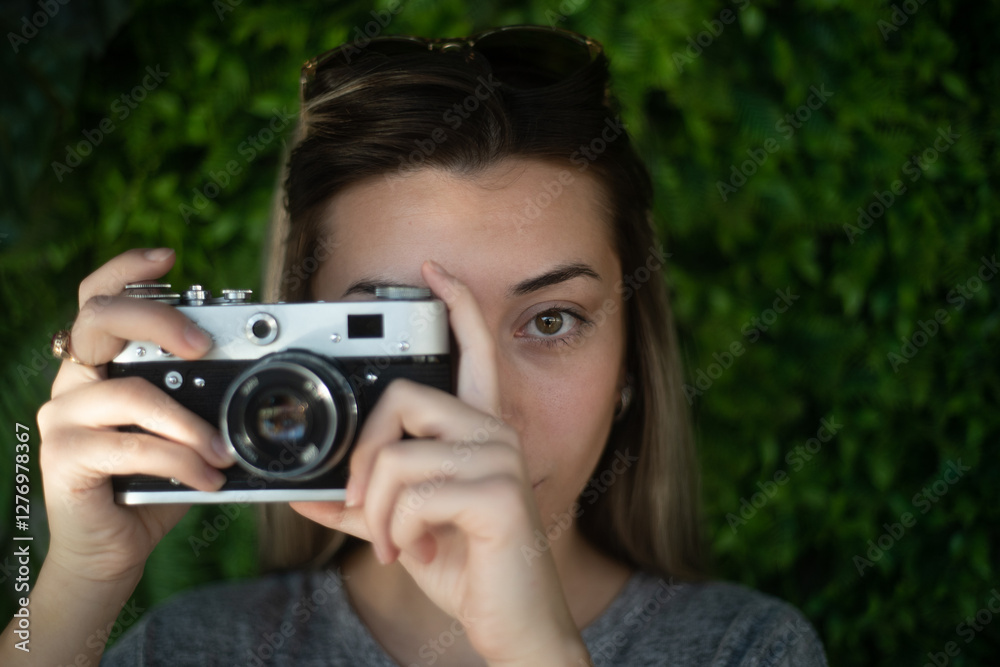 Woman taking a photo with a retro camera Woman taking a photo with a retro camera
