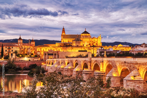 Illuminated Mezquita Cathedral and Roman Bridge in Cordoba at Sunset, Andalusia