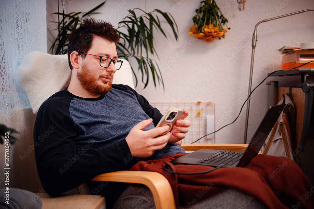 Fototapeta premium Man Looking at Smartphone with a Focused Expression