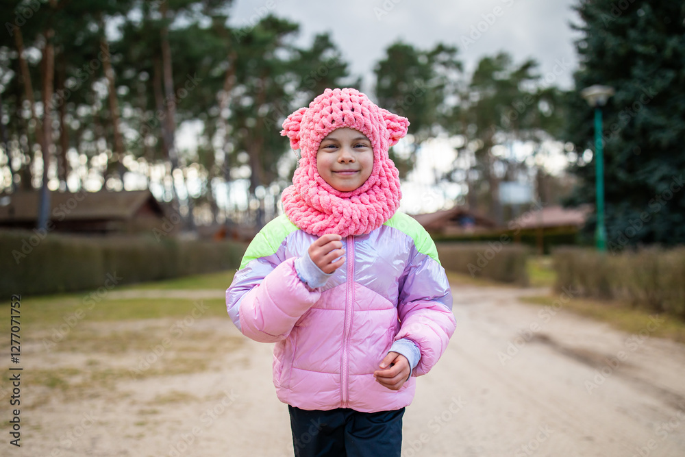 Little funny girl running in park outdoors